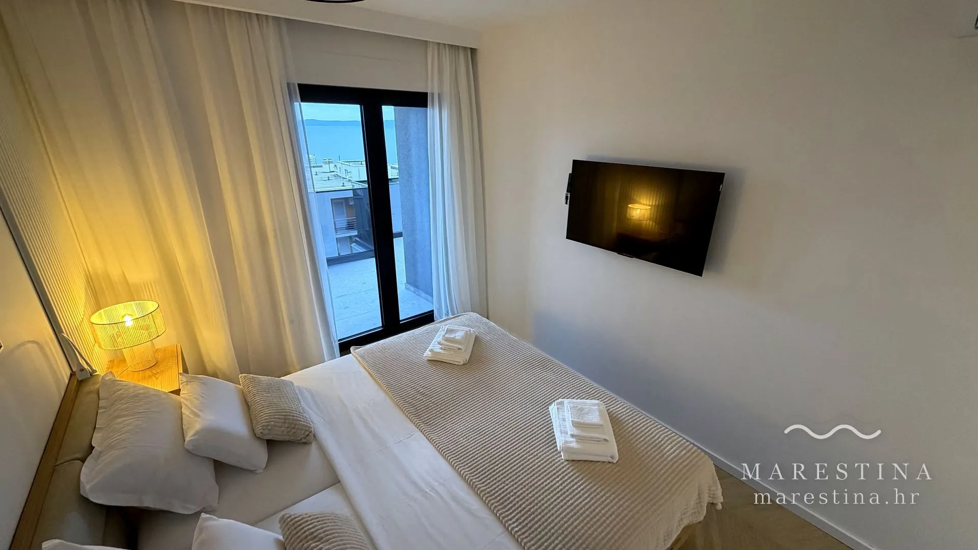 Main bedroom with double bed and balcony access